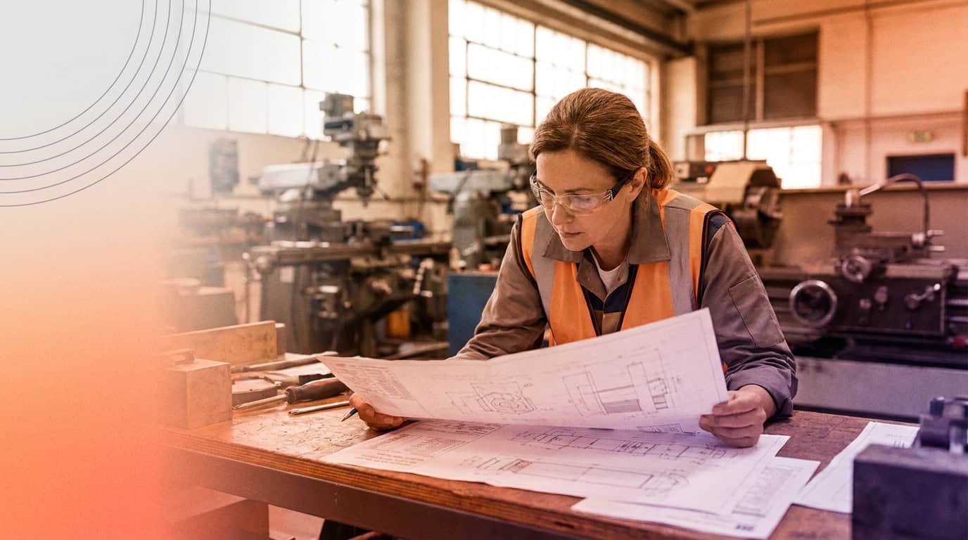 Engineer reviewing technical specifications on a manufacturing floor