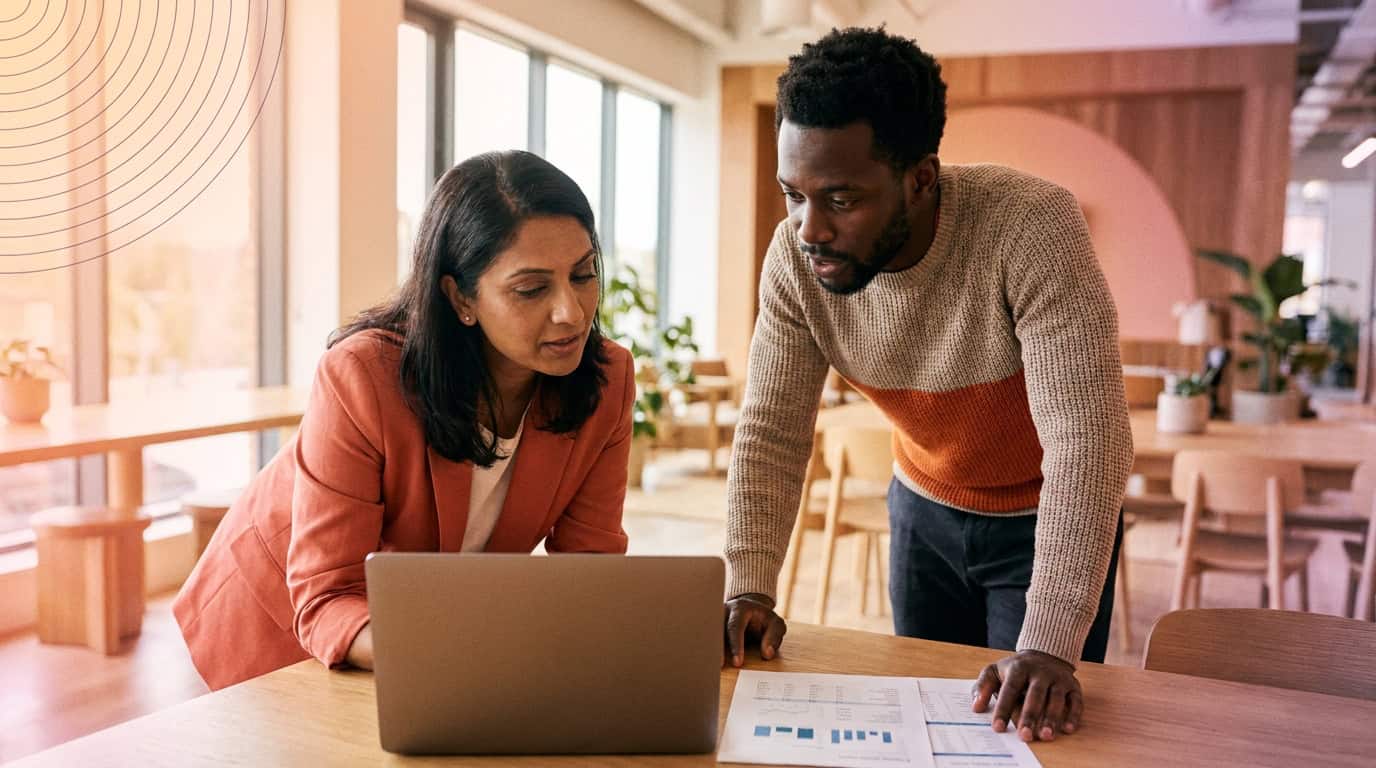 Business leaders comparing supplier options on a laptop during a planning meeting